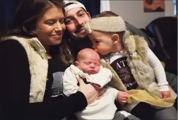  ?? Brian A. Pounds / Hearst Connecticu­t Media ?? Jacqueline, Anthony III and Anastasia Tenore, 19 months, welcome baby Anthony IV, the first baby born this year, in Norwalk on Monday. The baby was born at 12:11 a.m. on New Year’s Day.