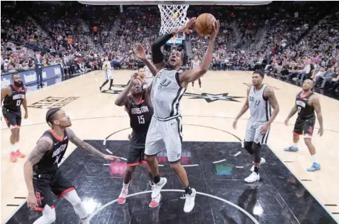  ?? — USA Today Sports ?? San Antonio Spurs’ Lamarcus Aldridge (12) shoots the ball as Houston Rockets’ Clint Capela (15) defends during the first half at AT&amp;T Center.