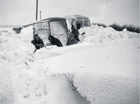  ??  ?? In drifts of 10ft, a bus and a van were stuck for days.