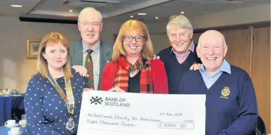  ??  ?? Big smiles Fiona Dennis (centre), a community fundraiser with Scotland’s Charity Air Ambulance, accepts a cheque for £8000 from Rotarians Alay Milne, Mike Hope, David Robb and Joe Cairns after last year’s silent auction