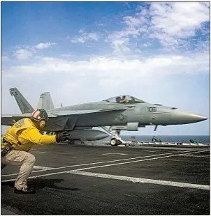  ?? AP/U.S. NAVY ?? In a photo released Saturday by the U.S. Navy, Lt. Nicholas Miller and Lt. Sean Ryan launch an F-18 Super Hornet from the deck of the USS Abraham Lincoln in the Arabian Sea.