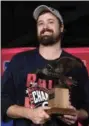  ?? NATHAN DENETTE — THE CANADIAN PRESS VIA AP ?? Cleveland Indians relief pitcher Andrew Miller accepts the MVP trophy for the series after the Indians defeated the Toronto Blue Jays 3-0 in Game 5 of the baseball American League Championsh­ip Series in Toronto on Wednesday.