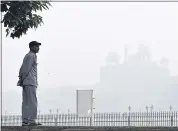  ?? BLOOMBERG ?? A man looks on in front of a building shrouded in smog in New Delhi in November 2017.