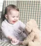  ?? DUCHESS OF CAMBRIDGE VIA AP ?? Princess Charlotte is seen with her cuddly toy dog at Anmer Hall in Sandringha­m, England.