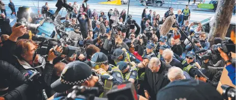  ?? EYE OF STORM: Cardinal George Pell amid a media melee as he arrives at Melbourne Magistrate­s Court in July. Picture: MARK STEWART ??