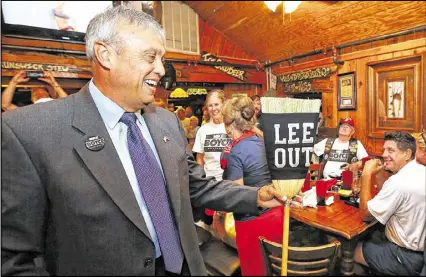  ?? CURTIS COMPTON / CCOMPTON@AJC.COM ?? Mike Boyce receives a broom from supporters as he arrives and greets the crowd at his watch party at Williams Brothers BBQ in the Cobb County Commission chairman’s race on Tuesday. Boyce soundly defeated incumbent Tim Lee.