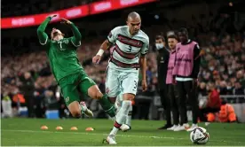  ?? Photograph: Stephen McCarthy/Sportsfile/Getty Images ?? Callum Robinson goes flying after a foul by Pepe which earned the Portugal defender a second yellow card.