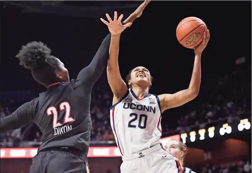  ?? Jessica Hill / Associated Press ?? UConn’s Olivia Nelson-Ododa (20) is fouled by Louisville’s Liz Dixon in the first half on Dec. 19.