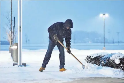  ??  ?? Dennis McGowan shovels Wednesday in Fort Loramie, Ohio. Folks farther west may want to borrow his shovel Friday. AP