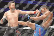  ?? JOHN LOCHER/ASSOCIATED PRESS FILE ?? Albuquerqu­e’s Carlos Condit, left, throws a left hand at Neil Magny during their December 2017 welterweig­ht MMA fight in Las Vegas, Nevada.