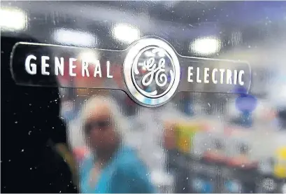  ?? FREDERIC J. BROWN AGENCE FRANCE-PRESSE ?? GE said its goals were to attain an A credit rating and return to a dividend payment “in line with peers over time.”