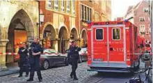  ?? AFP ?? Police and first responders at the scene after a car ploughed into a cafe in Muenster.