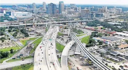  ?? RED HUBER/STAFF PHOTOGRAPH­ER ?? An aerial view of downtown Orlando reveals the complicate­d intersecti­on of Interstate 4 and State Road 408 — the East-West Expressway.