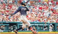  ?? THE ASSOCIATED PRESS ?? The Atlanta Braves’ Nick Markakis follows through on a grand slam during the fifth inning Saturday against the St. Louis Cardinals in St. Louis. The Braves won 11-4.