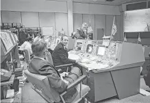  ?? NASA ?? John Hodge, from left, Christophe­r Kraft Jr. and Eugene Kranz discuss recovery operations for the Gemini-6 spacecraft in Mission Control on Dec. 16, 1965.