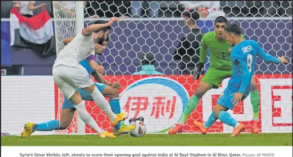  ?? Picture: AP PHOTO ?? Syria’s Omar Khrbin, left, shoots to score their opening goal against India at Al Bayt Stadium in Al Khor, Qatar.