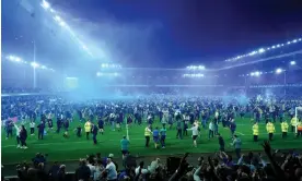  ?? Peter Byrne/PA ?? Everton fans storm the Goodison Park pitch after avoiding relegation last season. Photograph: