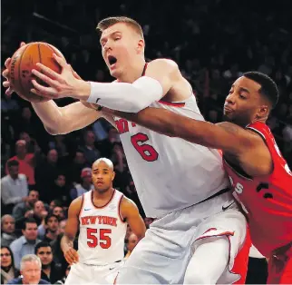  ?? JULIE JACOBSON/THE ASSOCIATED PRESS ?? Toronto Raptors forward Norman Powell tries to strip the ball from New York Knicks forward Kristaps Porzingis during NBA action Wednesday night New York. Although the Raptors held Porzingis pretty much in check, the Knicks were 108-100 winners.