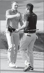  ?? TOMPENNING­TON/GETTY IMAGES ?? Jordan Spieth, left, congratula­tes Jason Day on his PGAwin. Spieth placed second and moved to No. 1 in the rankings.