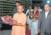  ?? HT ?? Chief minister Yogi Adityanath, accompanie­d by Ayodhya DM Anuj Jha and priests, shifts the idol of Ram Lalla from the makeshift temple to a new structure, in Ayodhya, on Wednesday.