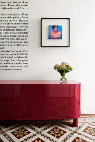  ??  ?? Hallway 19th-century features like the stained-glass windows and glass chandelier­s were left untouched. The burgundy ‘Preston’ sideboard by Jardan complement­s the tones of the intricate mosaic flooring and the bold artwork (right) is by Dean Reilly