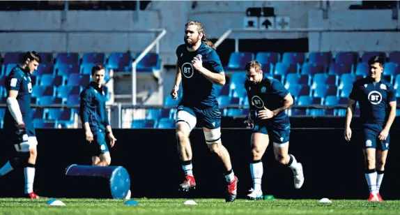  ??  ?? Best foot forward: Scotland second row Ben Toolis leads the squad in a warm-up at the Stadio Olimpico in Rome in preparatio­n for today’s encounter