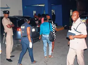  ?? FILE ?? In this January 2016 photo, police detain a group of alleged female street sex workers in Montego Bay, St James.