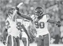  ?? Brett Coomer / Houston Chronicle ?? Texans linebacker Jadeveon Clowney, right, celebrates with Brian Peters after sacking Ravens quarterbac­k Joe Flacco during the first quarter of Monday night’s game in Baltimore.