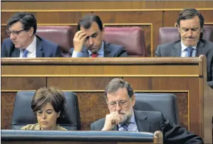  ?? AP PHOTO ?? In this file photo, Spain’s Prime Minister and Popular Party leader Mariano Rajoy, lower row right, and Deputy Prime Minister Soraya Saenz de Santamaria attend the national budget debate at the Spanish parliament in Madrid. Spain’s Prime Minister...