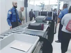  ?? — Reuters ?? Baggage and a laptop are scanned using the Transport Security Administra­tion’s new Automated Screening Lane technology at Terminal 4 of JFK airport in New York City.