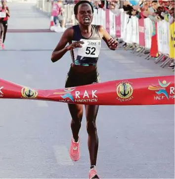  ?? Courtesy: Organisers ?? Kenyan Peres Jepchirchi­r crosses the line in record time at the RAK Half Marathon yesterday.