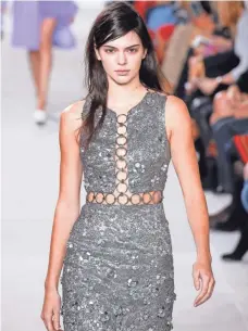  ?? PHOTOS BY JP YIM, GETTY IMAGES FOR MICHAEL KORS ?? Kendall Jenner, walks the Michael Kors Fall 2016 runway in a metalic, floral brocade dress. The show also featured pairings of tweed and florals.