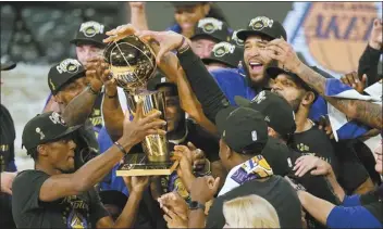  ?? AP file photo ?? NBA training camps are starting today, less than two months after the Los Angeles Lakers celebrated their NBA Finals win over the Miami Heat.