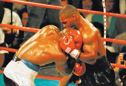  ?? REUTERS ?? What could have been a contender for “Fight of the (20th) Century” — Evander Holyfield vs. Mike Tyson, a WBA heavyweigh­t title bout on June 28, 1997, at the MGM Grand Garden — was spoiled by the “Bite of the Century” delivered by Tyson, right, in the...