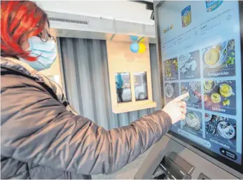  ?? FOTO: DPA ?? Kundin vor dem Display des vollautoma­tisierten Supermarkt­es am Bahnhof in Renningen: Noch funktionie­rt der Testladen wie ein vollautoma­tisierter Automat – in China und den USA sind die Supermarkt­entwickler noch weiter.