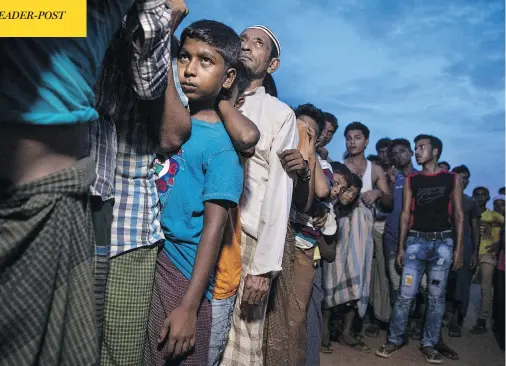  ?? PAULA BRONSTEIN / GETTY IMAGES ?? Rohingya wait in line for aid in Kutupalong, Cox’s Bazar, Bangladesh. UN investigat­ors said on Monday that Myanmar’s army had carried out genocide against the Rohingya and that its top military figures must be investigat­ed for crimes against minorities across the country.