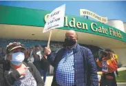  ?? Lea Suzuki / The Chronicle ?? Laidoff Golden Gate Fields concession stand manager Cindy Souza and bartender Alfonso Garcia protest not being recalled to their old jobs.