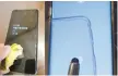  ?? Korea Times file ?? Users try to unlock Samsung Electronic­s’ Galaxy S10 and Note 10 smartphone­s with a persimmon peel (left) and a stylus pen.