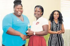  ??  ?? Jahmeilea Ogeare, collects her trophy from JN Foundation’s Chevanese Peters.In the background is Melecia Doherty, English language teacher, Mile Gully High School, one of the four high schools which participat­ed in the TEACH Caribbean programme.