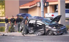  ?? ADOLPHE PIERRE-LOUIS/JOURNAL ?? APD officers and Bernalillo County sheriff’s deputies investigat­e a crash involving an Albuquerqu­e police officer and a family at the intersecti­on of Eubank and Indian School NE.