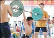  ?? GETTY IMAGES ?? In this picture taken in 2012, a young boy trains at a weightlift­ing school in Xiamen, Fujian province, in China.