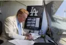  ?? Photograph: Jae C Hong/AP ?? Vin Scully works in his booth at Dodger Stadium in Los Angeles during a 2010 game.