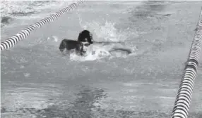  ??  ?? Tyler Evans trains in the pool at the U.S. Olympic Training Center in Colorado Springs. Evans, a triathlete, was recently treated by doctors at National Jewish Health in Denver for vocal cord dysfunctio­n. Provided by National Jewish Health