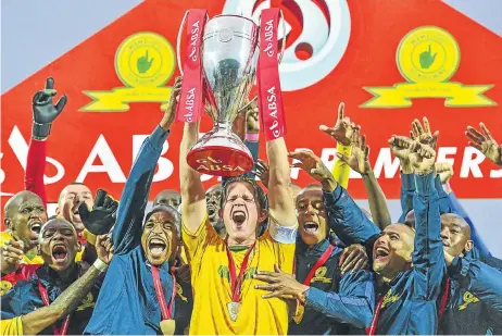  ?? Picture: BACKPAGEPI­X ?? IT’S SAMBA TIME: Sundowns skipper AljIe Schut and his teammates celebrate with the Absa Premiershi­p trophy at Harry Gwala Stadium yesterday