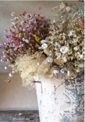  ??  ?? GARDEN STUDIO Top and above Belle prepares to photograph dried flower arrangemen­ts