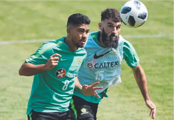 ?? Picture: SAEED KHAN ?? Australian midfielder­s Massimo Luongo and Mile Jedinak battle it out at Socceroos training in Kazan.