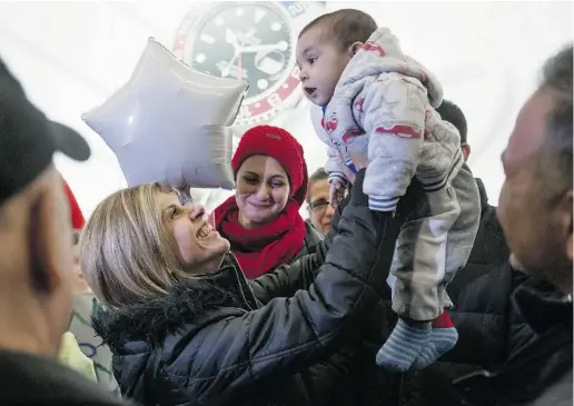  ?? Daryl Dyck / The Canadian
Pres ?? Tima Kurdi, left, who lives in Coquitlam, B.C., lifts her five-month- old nephew Sherwan Kurdi after her brother Mohammad Kurdi and his family, who escaped the war in Syria, arrived at Vancouver Internatio­nal Airport on Monday. Tima Kurdi’s other...