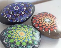  ??  ?? Colorfully-painted mandala stones in Hopkinton, N.H. The stones can serve as paperweigh­ts or decorative accents around the home.