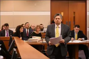  ?? THE MORNING JOURNAL FILE ?? Defense attorney Michael J. Camera returns to his seat in the jury box after being appointed to represent a client deemed indigent during an arraignmen­t hearing Feb. 22, 2018, in front of Lorain County Common Pleas Court Judge Raymond J. Ewers. Arraignmen­ts are often when defendants learn what their bond will be.