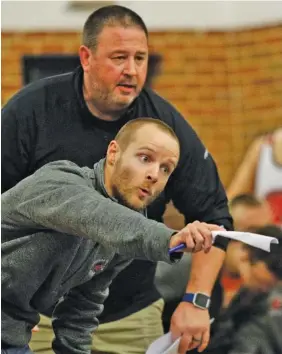  ?? STAFF FILE PHOTO BY DOUG STRICKLAND ?? Signal Mountain high school coaches Joe Jellison, front, and Casey Thompson shout instructio­ns during a past match. The Eagles finished second at state duals Saturday.